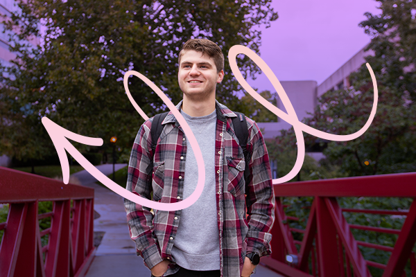 Male student on campus with a peach arrow pointing left